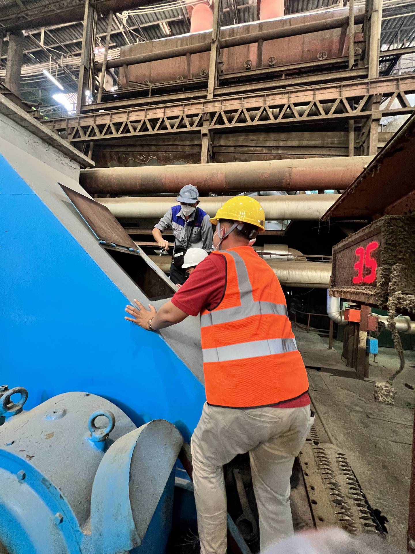 PEO Group service technicians servicing an installed industrial laundry machine on site