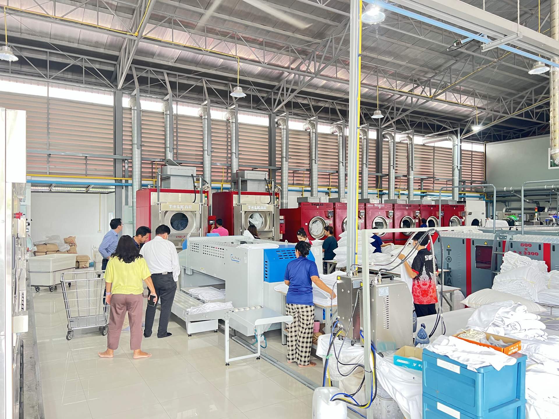 Wide view of Ideal Laundry's plant floor processing hospital and hotel linen at scale